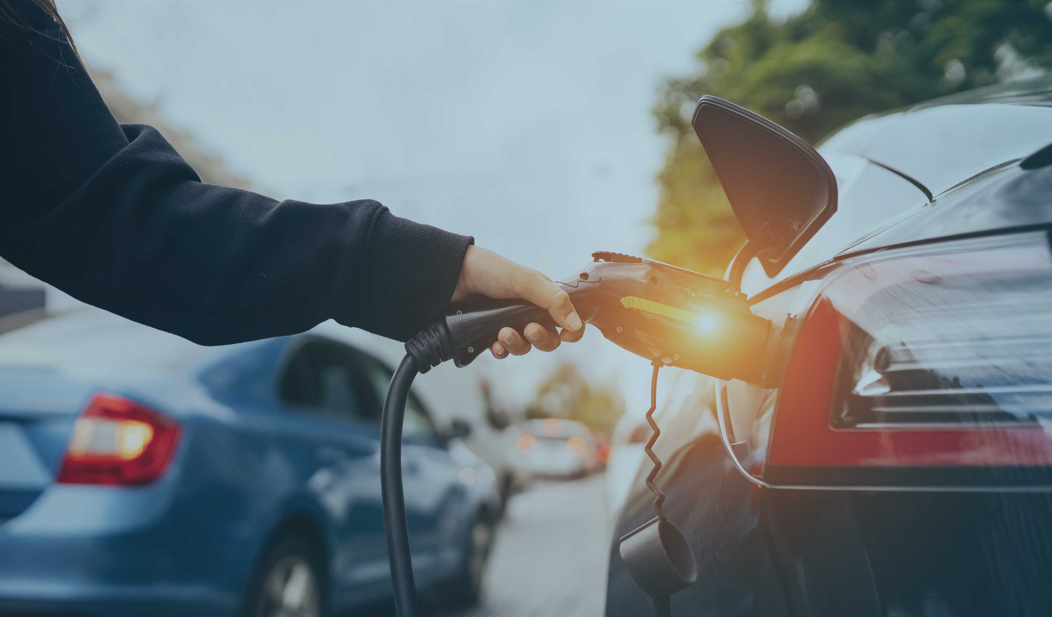 Someone charges an electric car