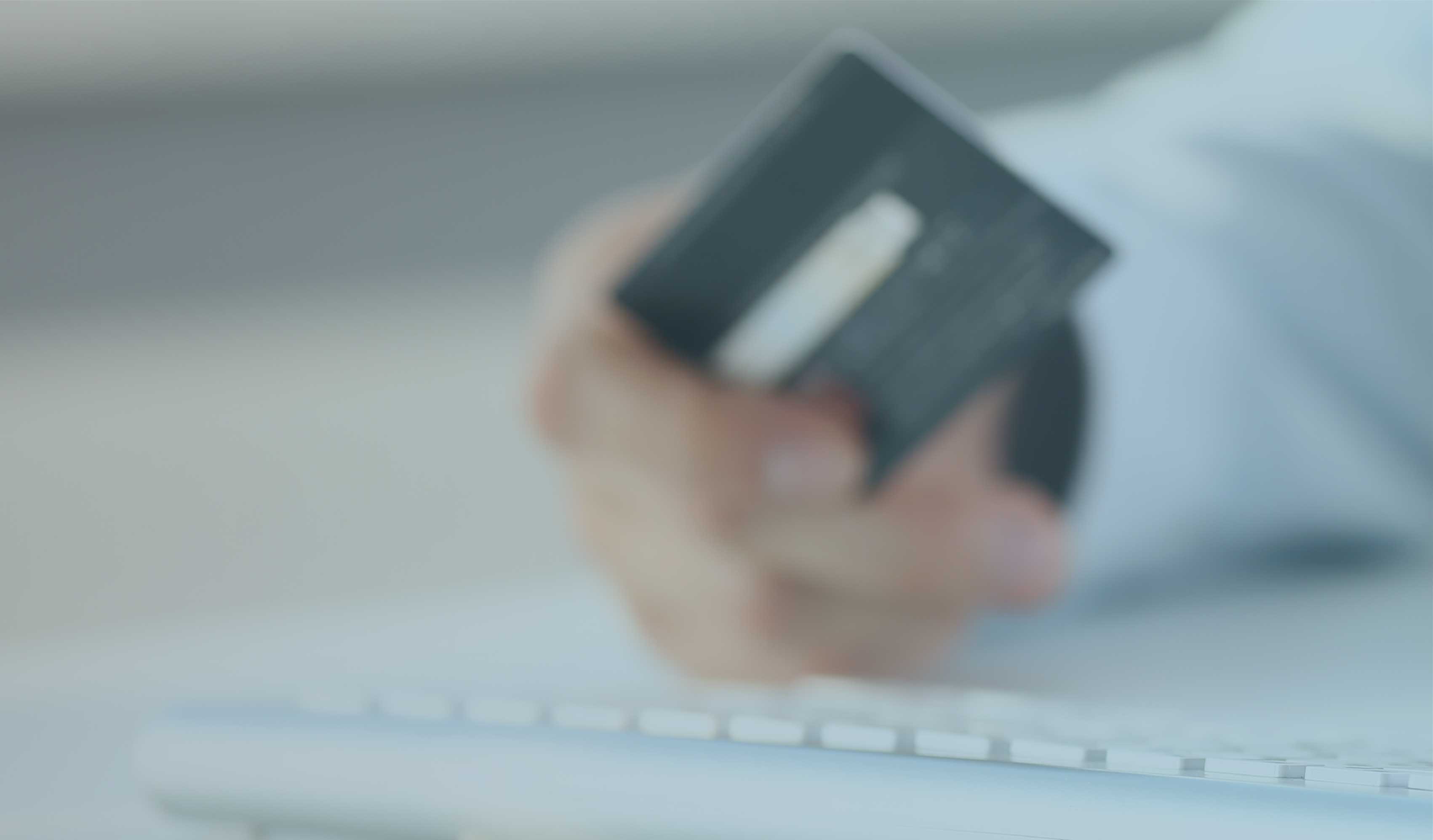 Person holding a credit card for payment